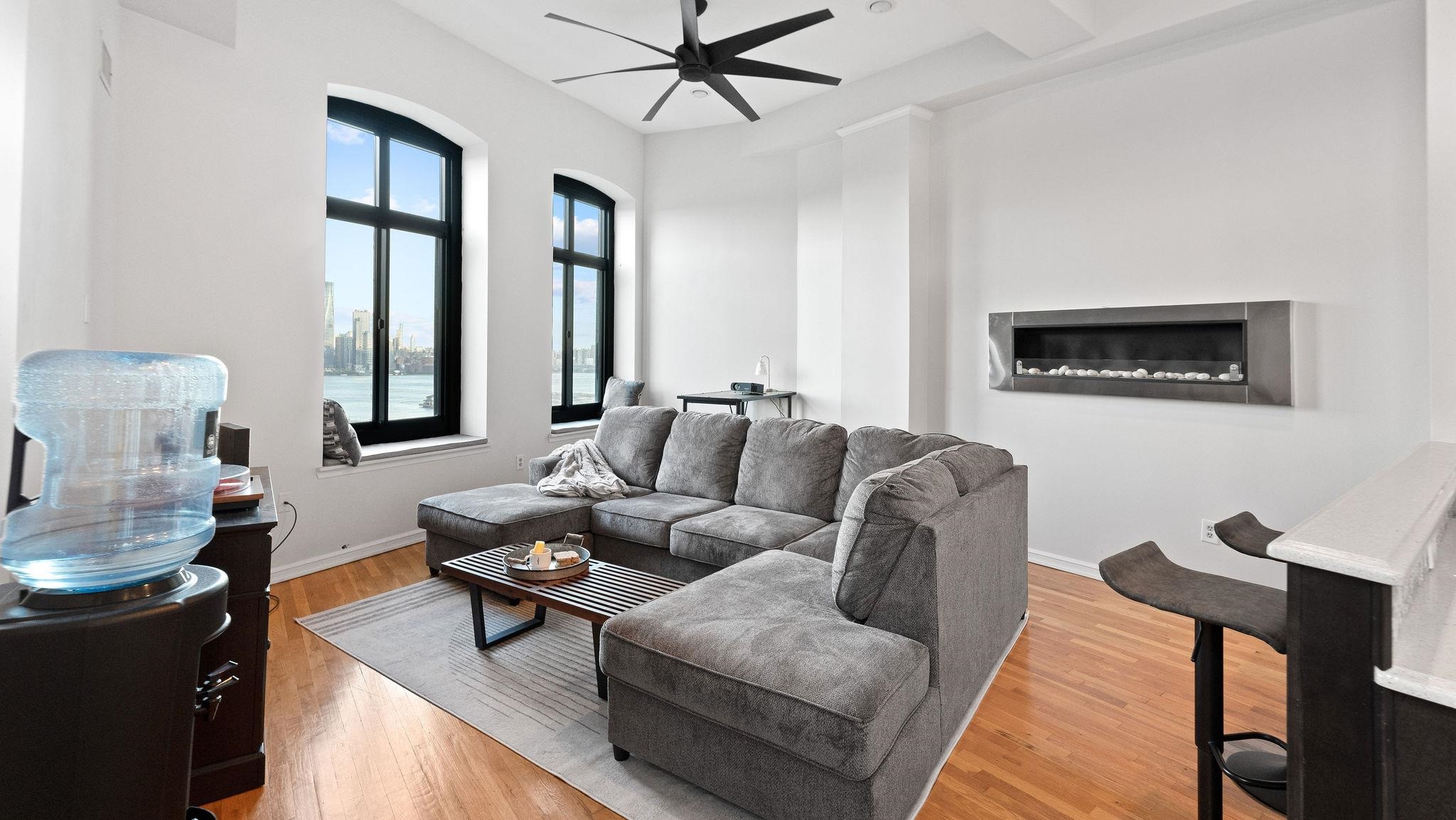 a living room with furniture and a painting on the wall