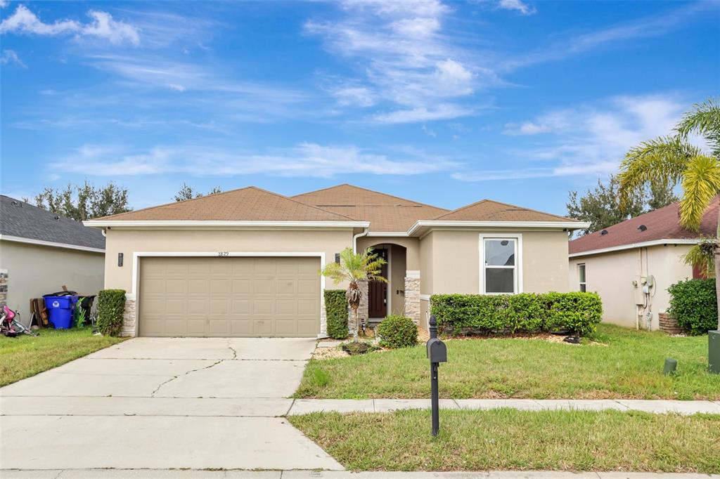 a front view of a house with a yard and garage