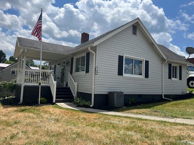 a view of a house with a balcony and yard