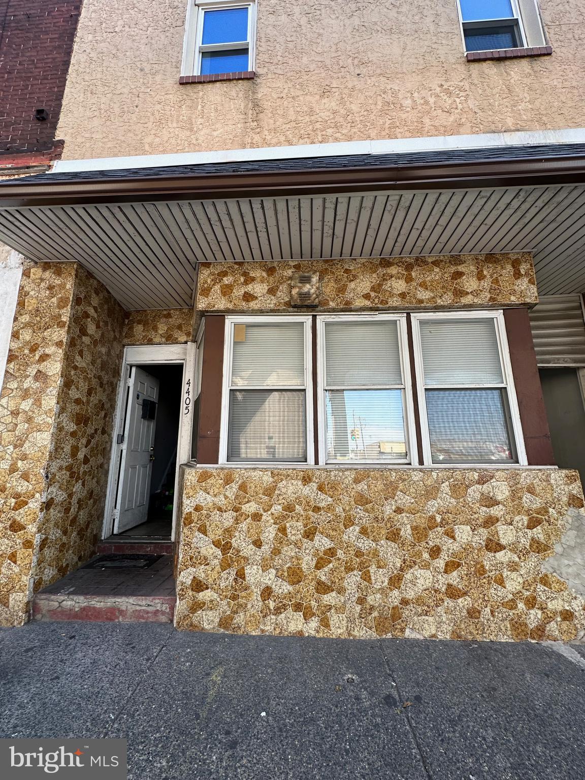 a front view of a house with large windows