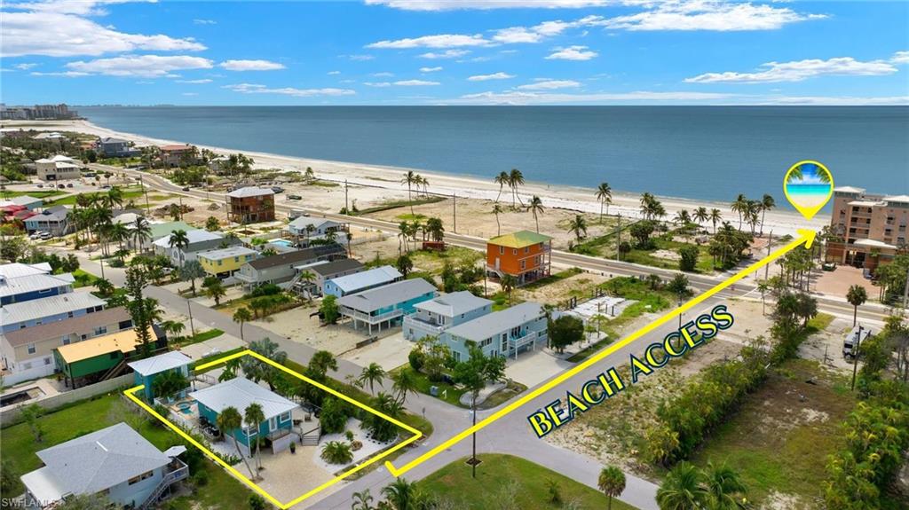 Drone / aerial view featuring a beach view and a water view