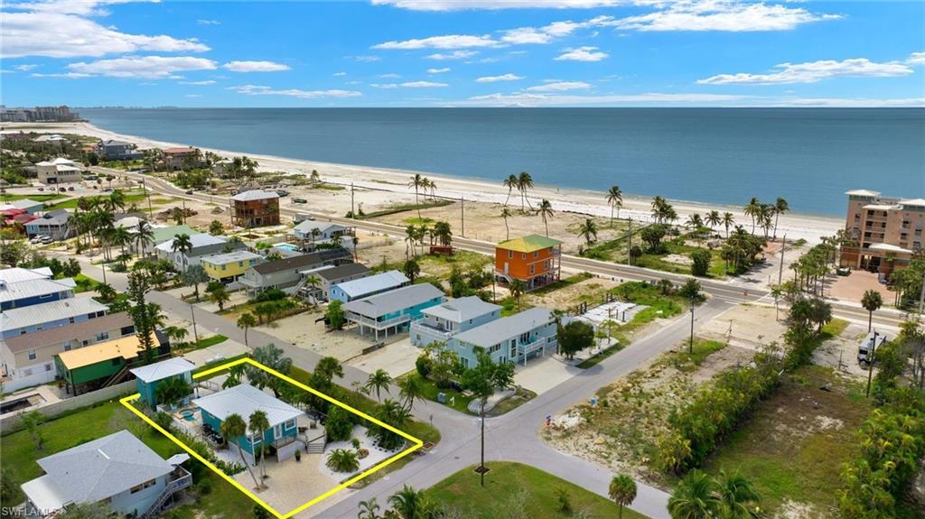 Drone / aerial view featuring a water view and a beach view