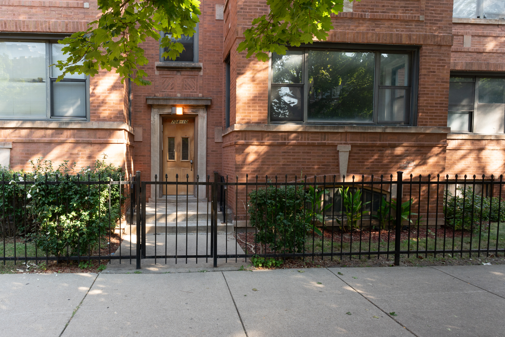 front view of a house with a iron gate