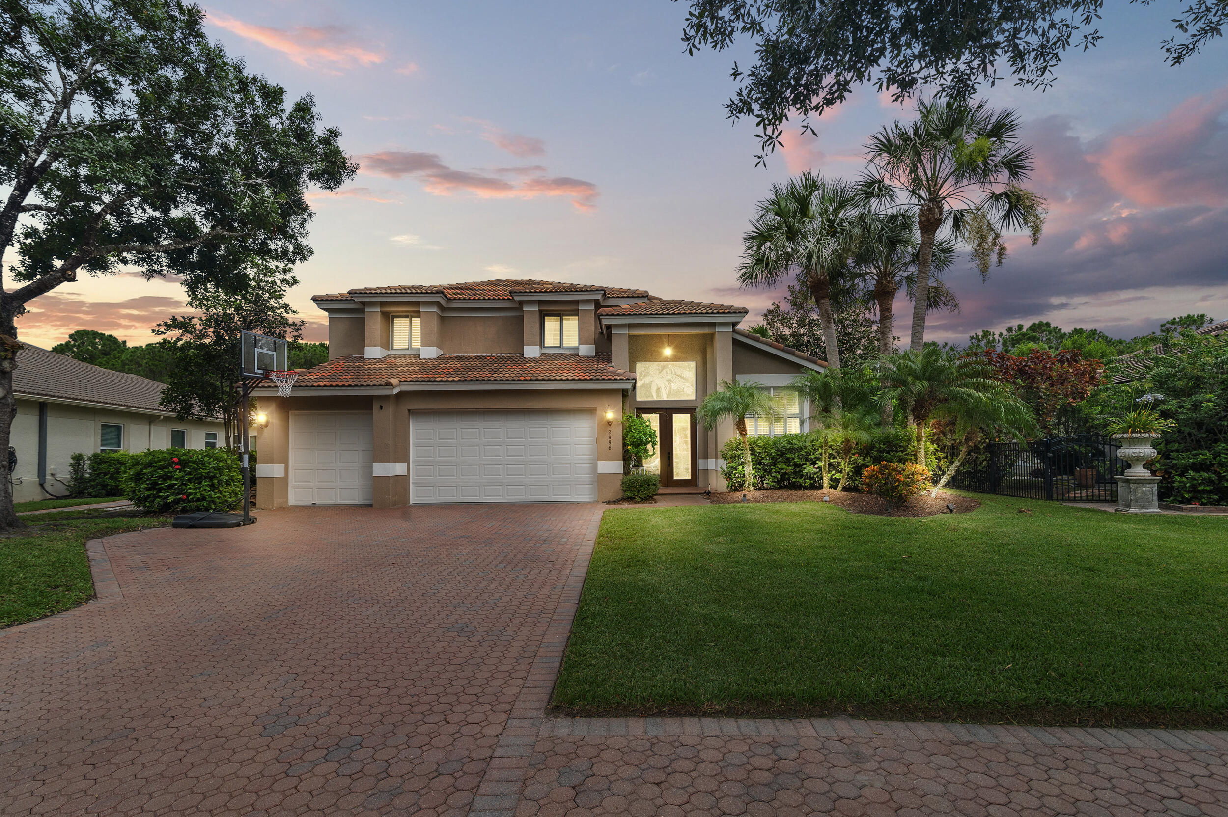 a front view of a house with a garden and yard