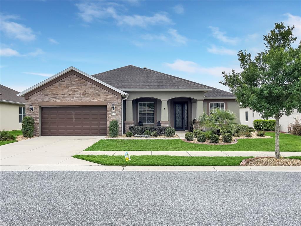 a front view of a house with a yard and garage