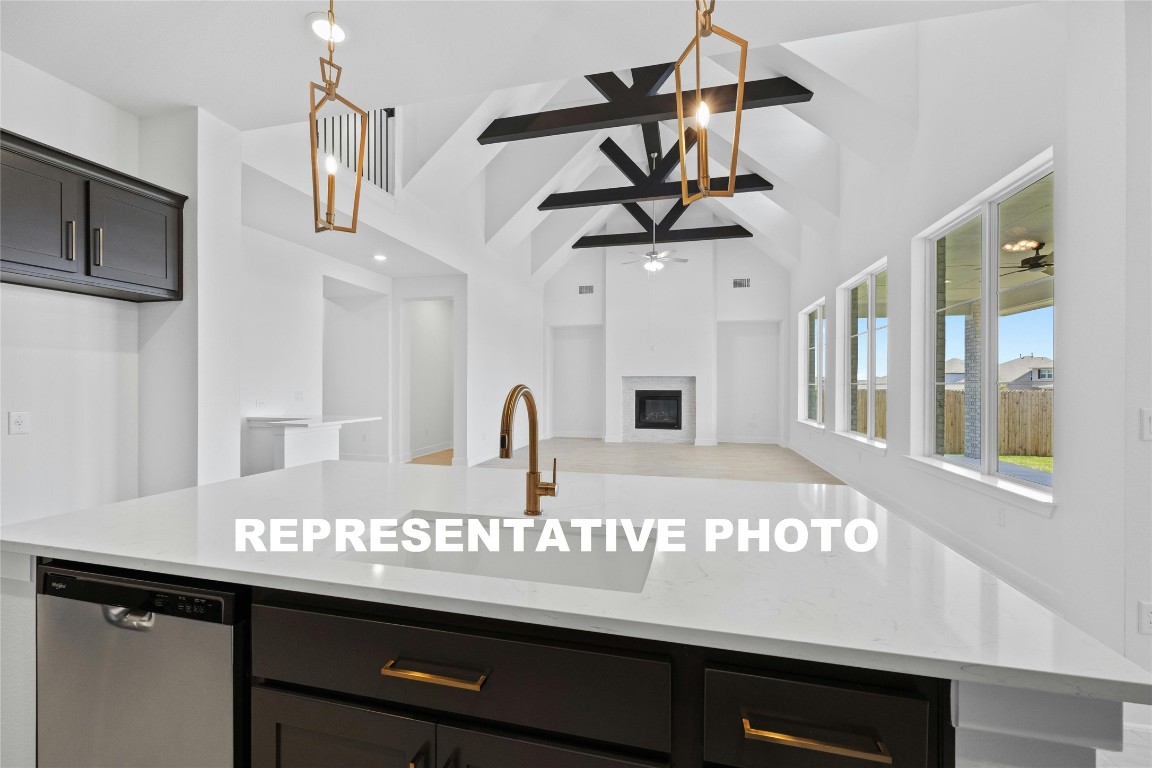 a view of a kitchen with stainless steel appliances granite countertop a sink and cabinets