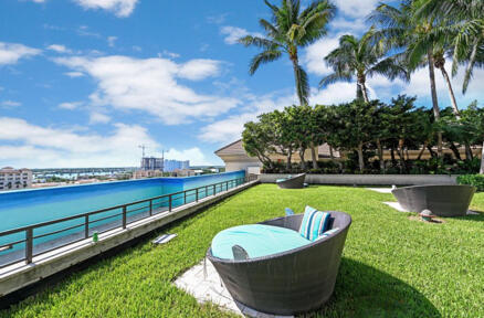 a view of a swimming pool with a patio and a yard