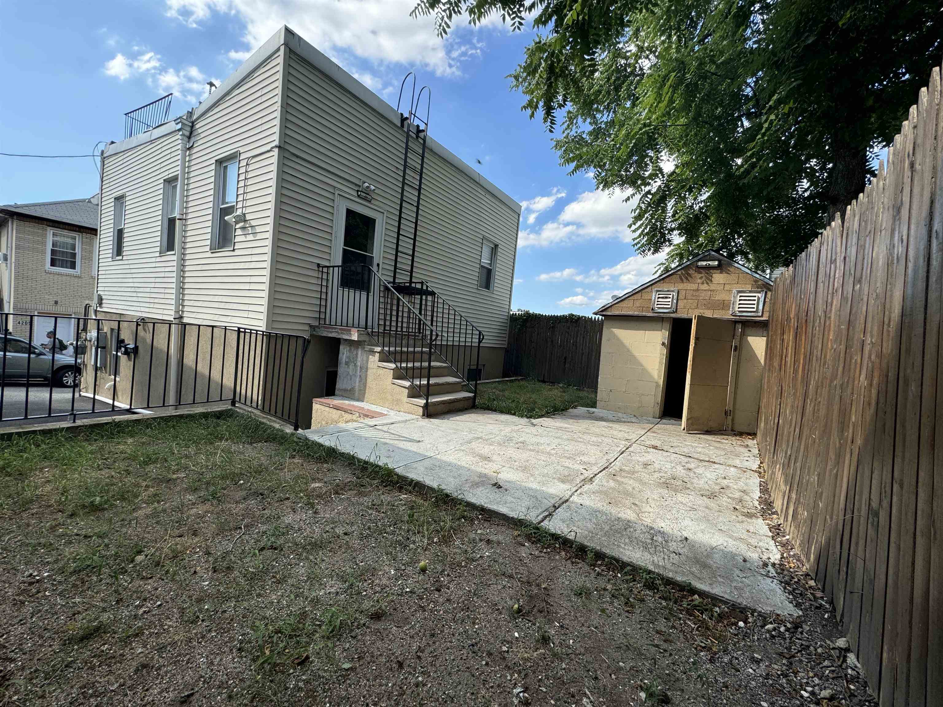 a view of a house with backyard and sitting area