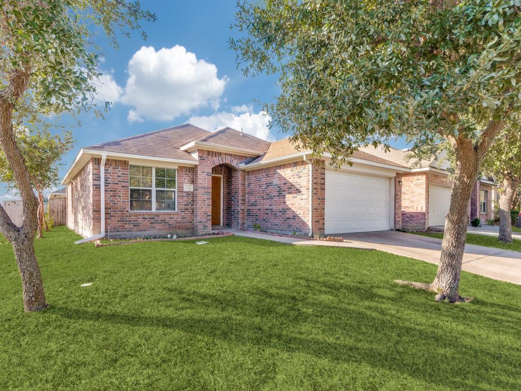 a front view of a house with a garden and yard