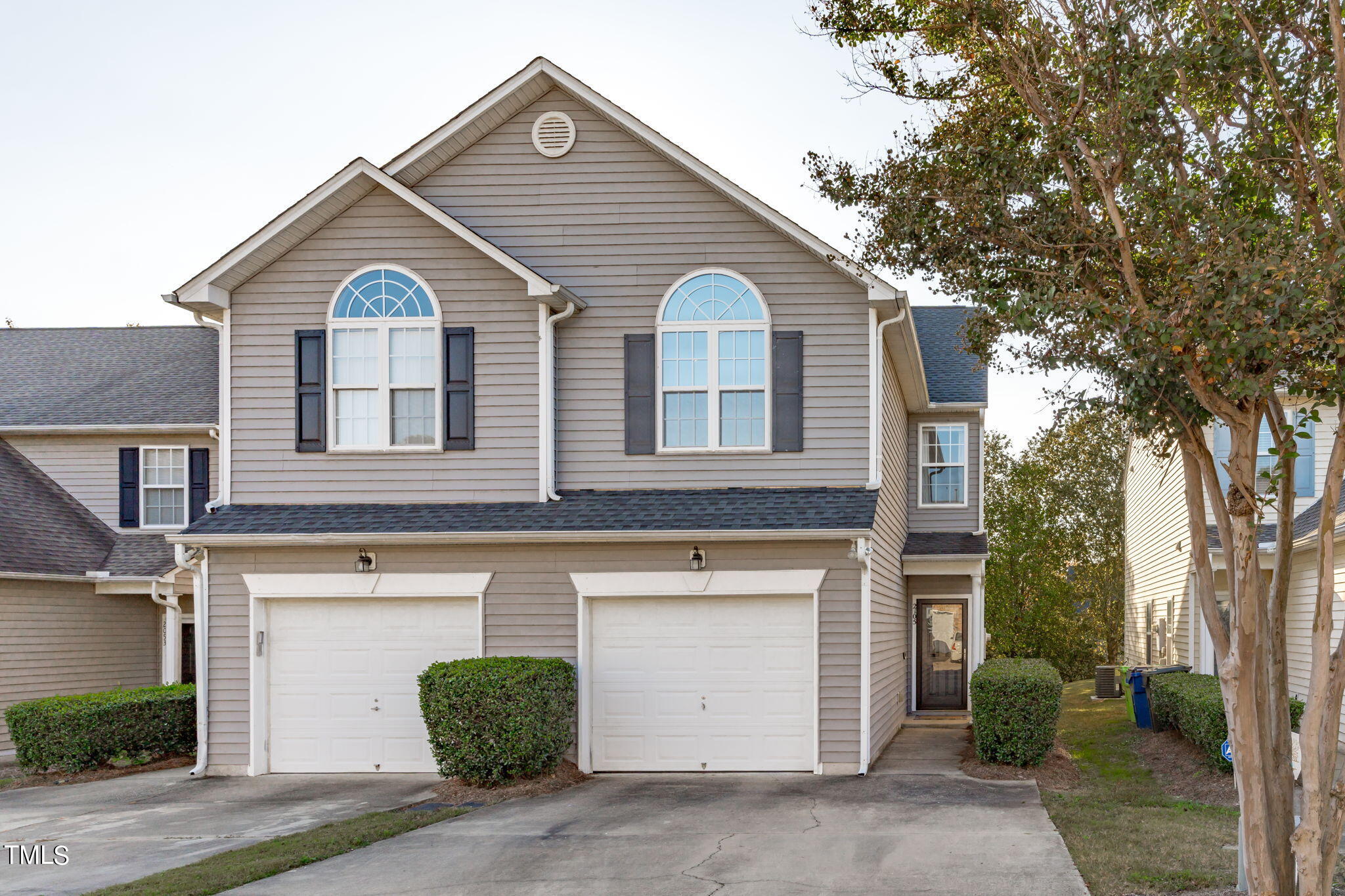 a view of a house with a yard and garage