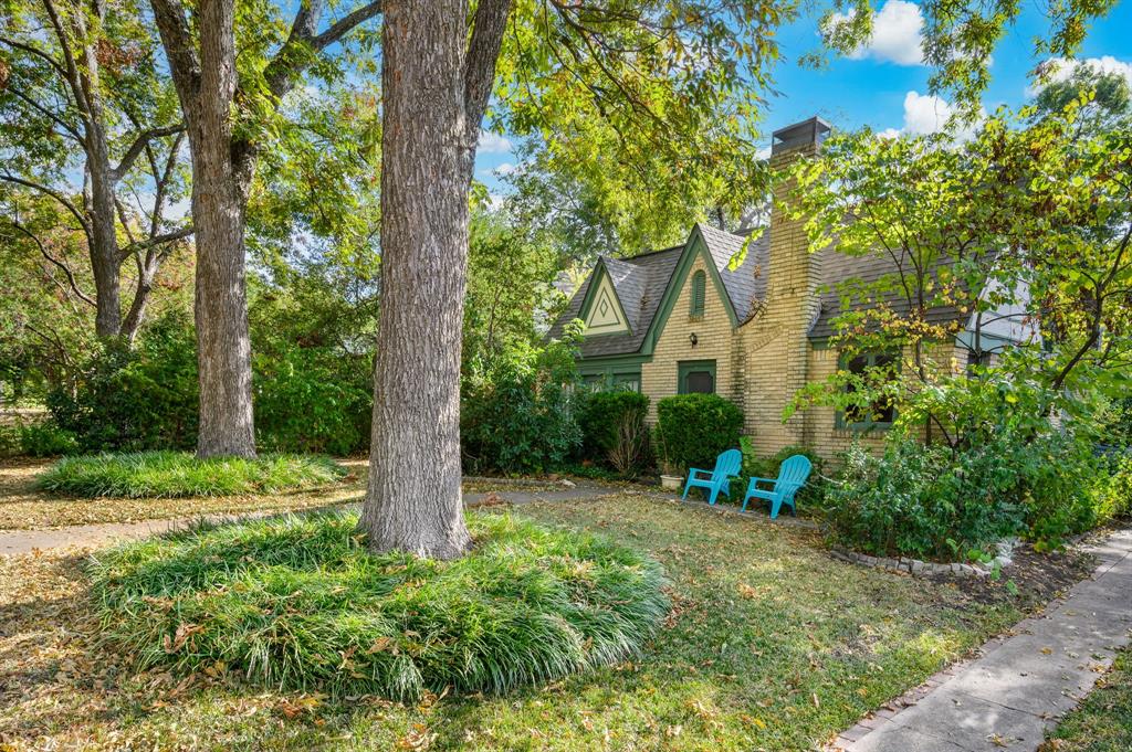 a view of a house with a tree and garden