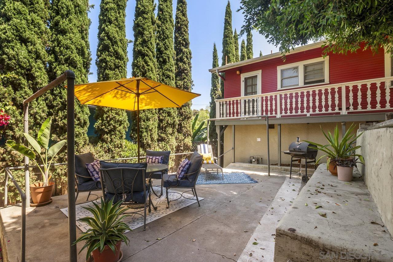 a view of a cafe with a table and chairs under an umbrella