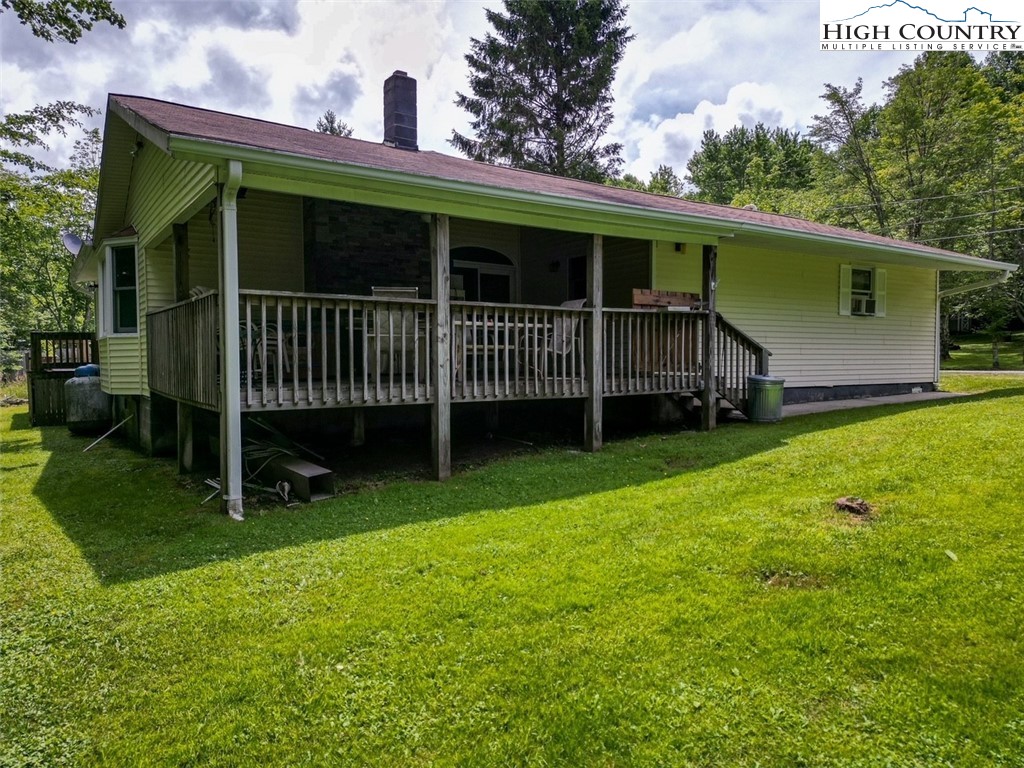 a view of a house with a yard and sitting area