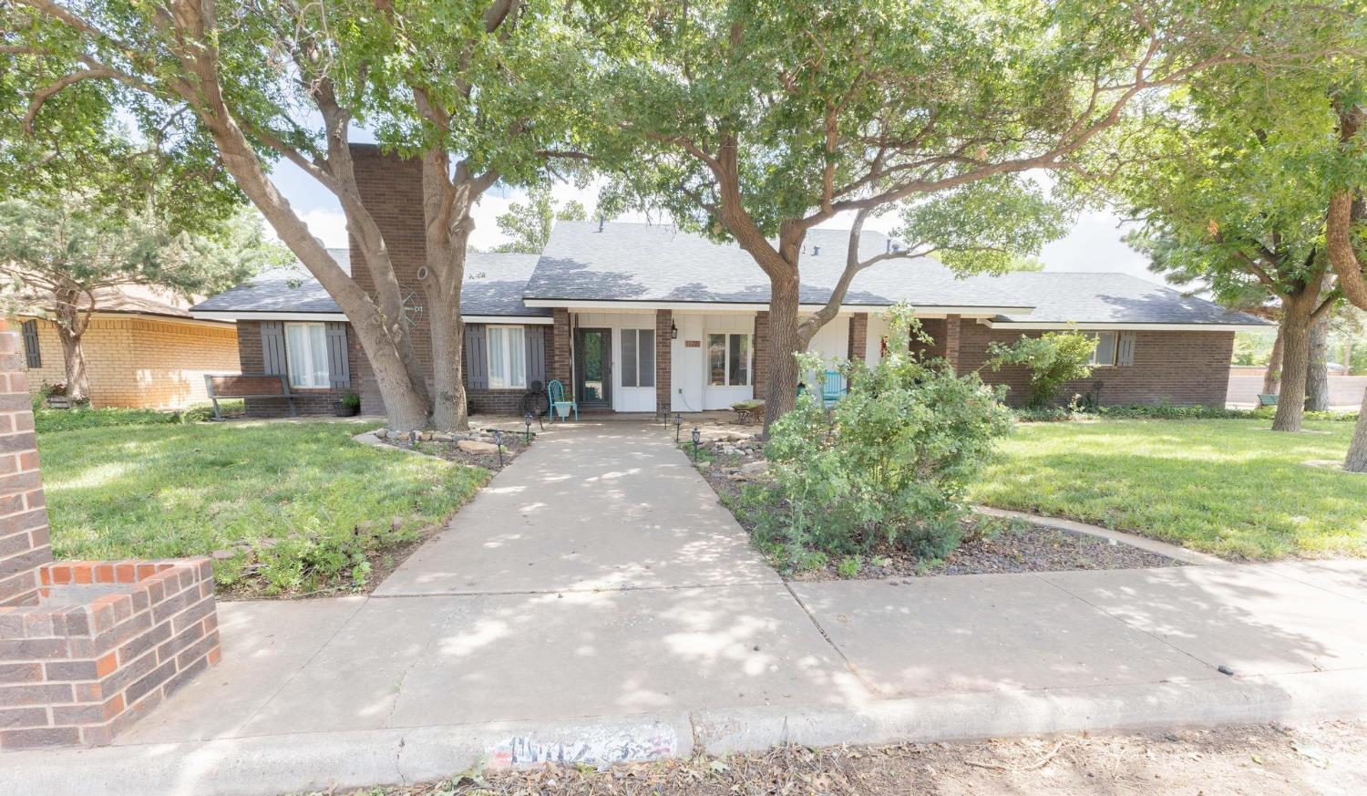 a front view of house with yard and green space