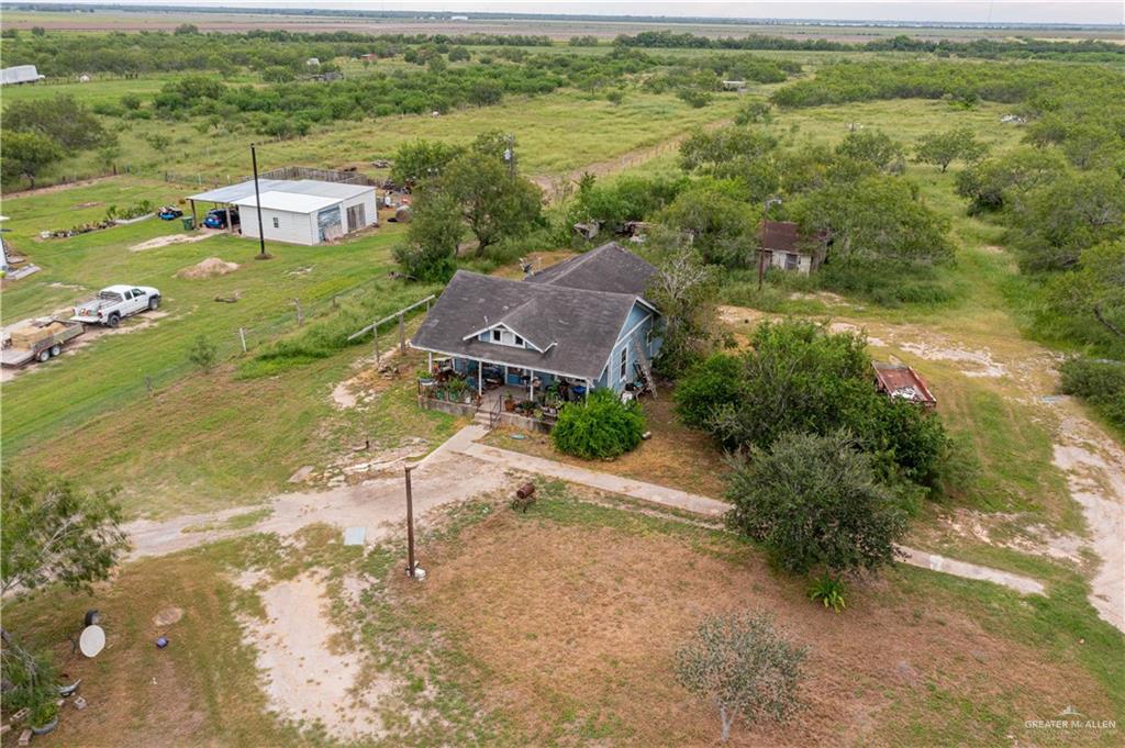 an aerial view of a house with a garden and lake view