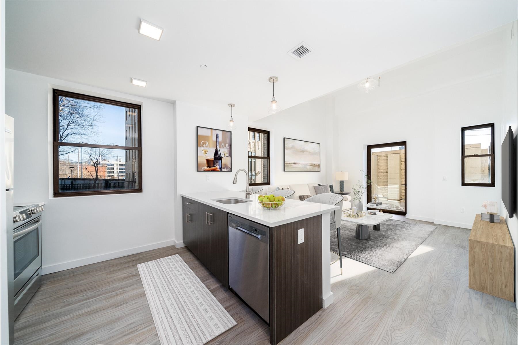 a kitchen with granite countertop a sink and a stove top oven