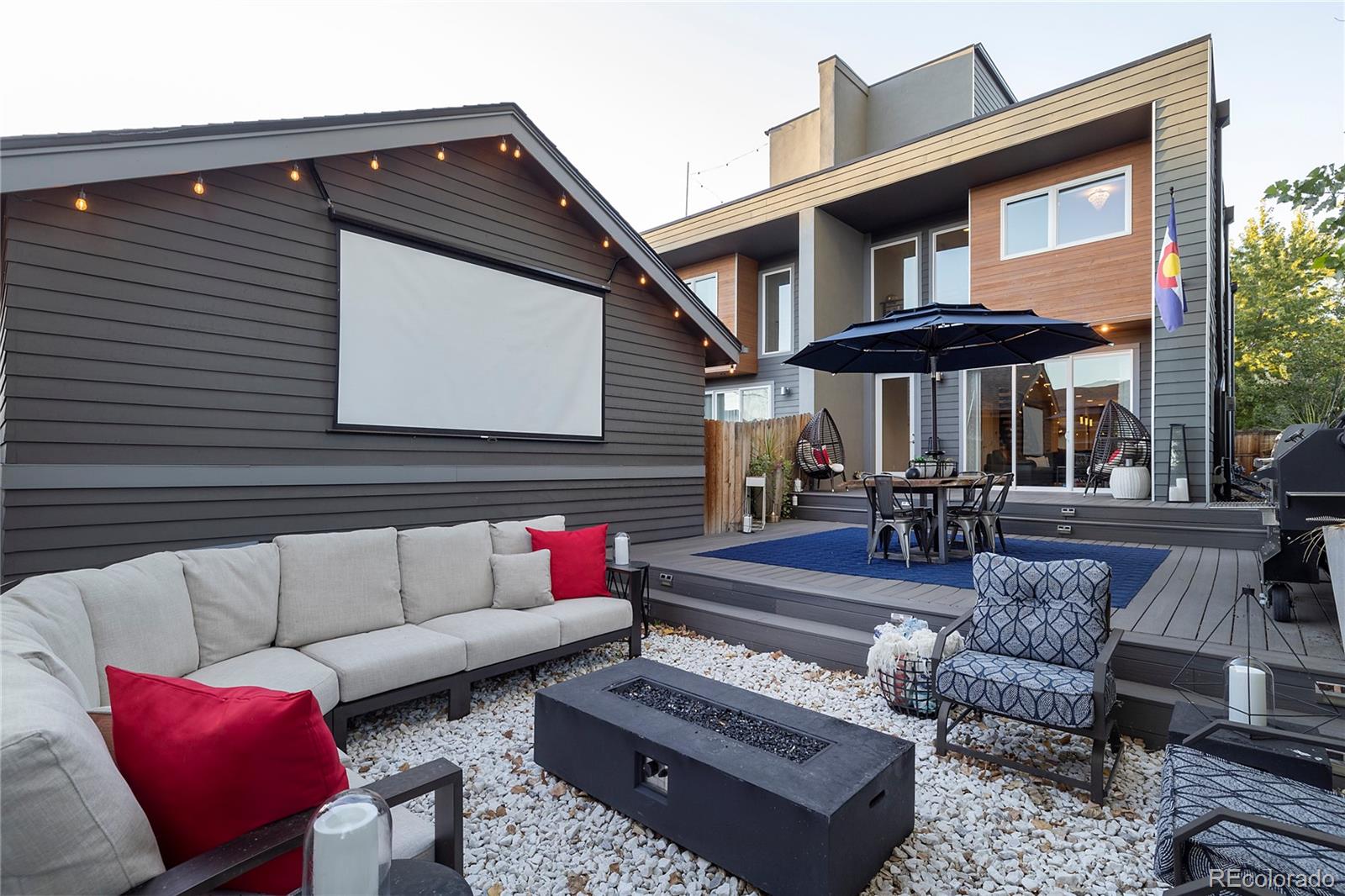 a view of a patio with couches table and chairs with wooden floor