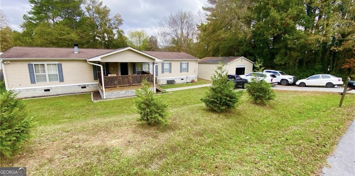 a view of a house with a yard porch and sitting area