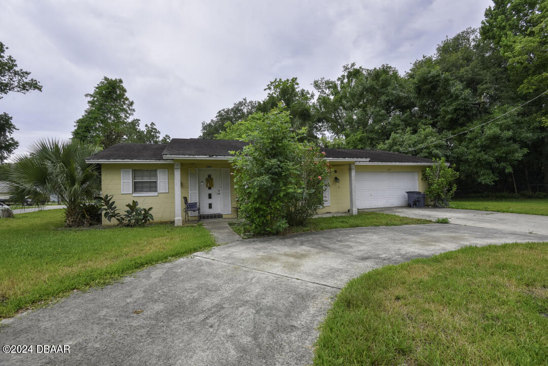 a front view of house with yard and green space