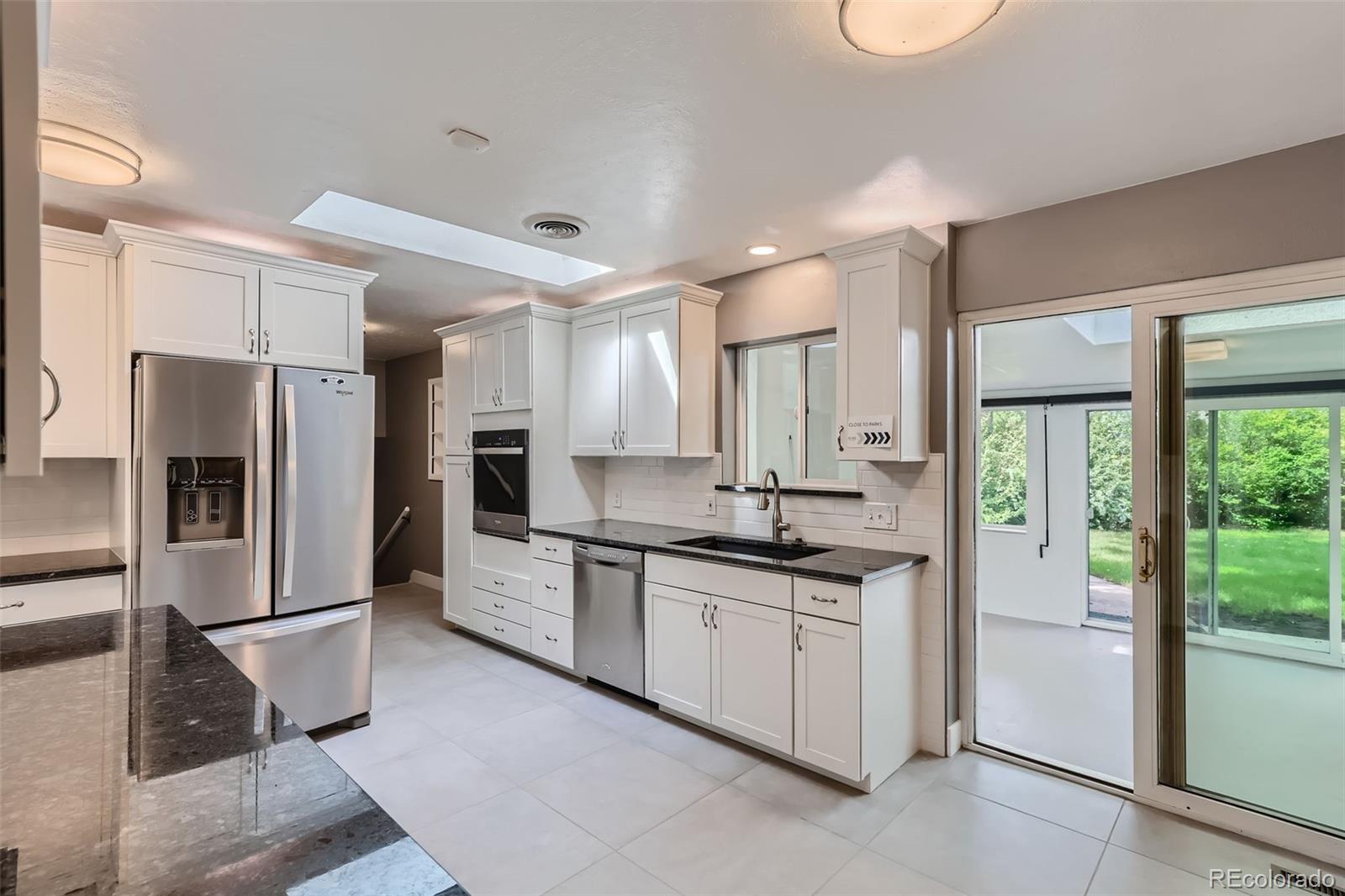 a kitchen with stainless steel appliances a refrigerator sink and stove