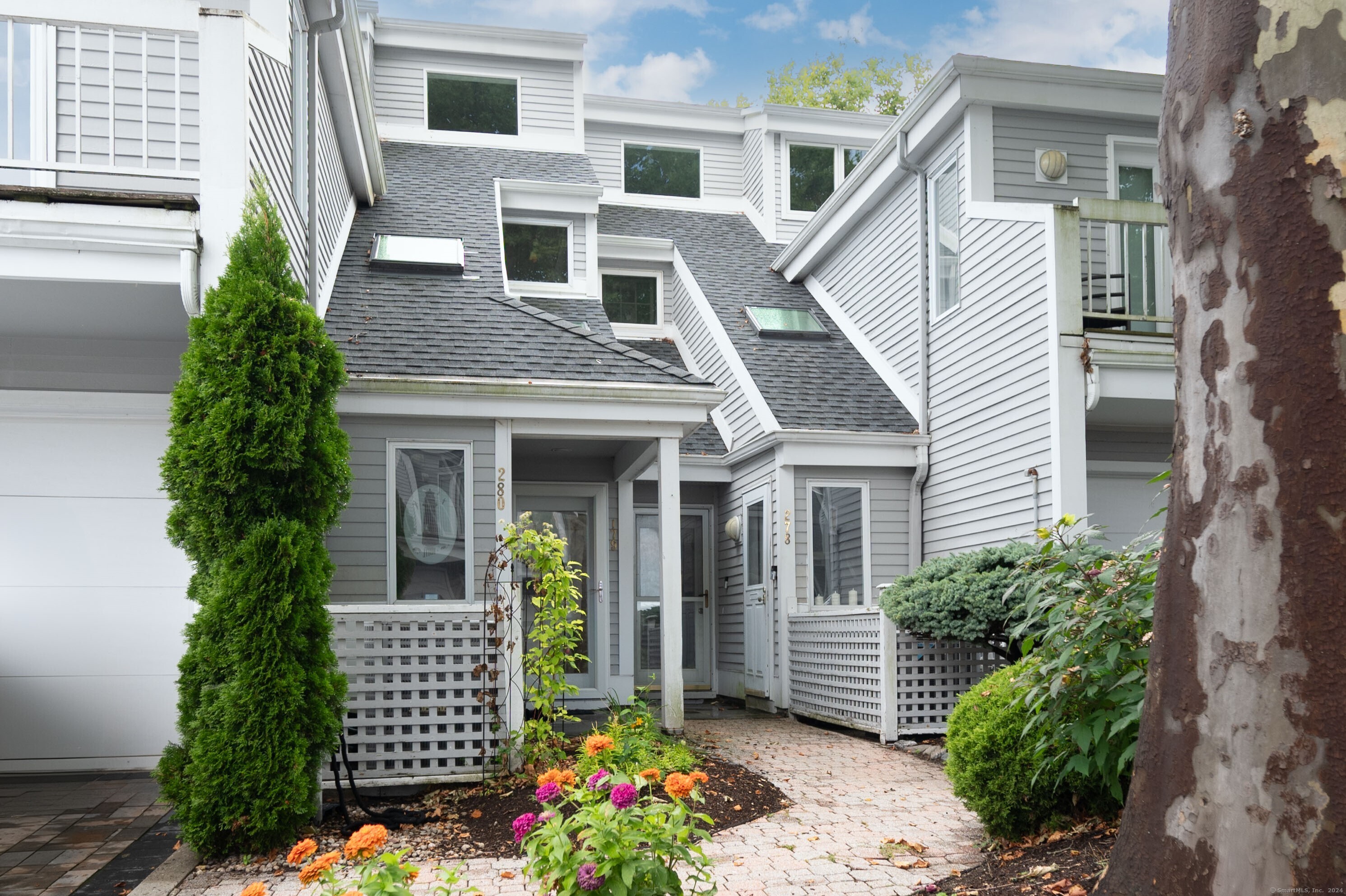 a front view of a house with a garden