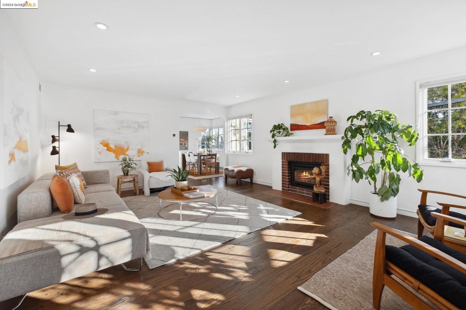 a living room with furniture a fireplace and a potted plant