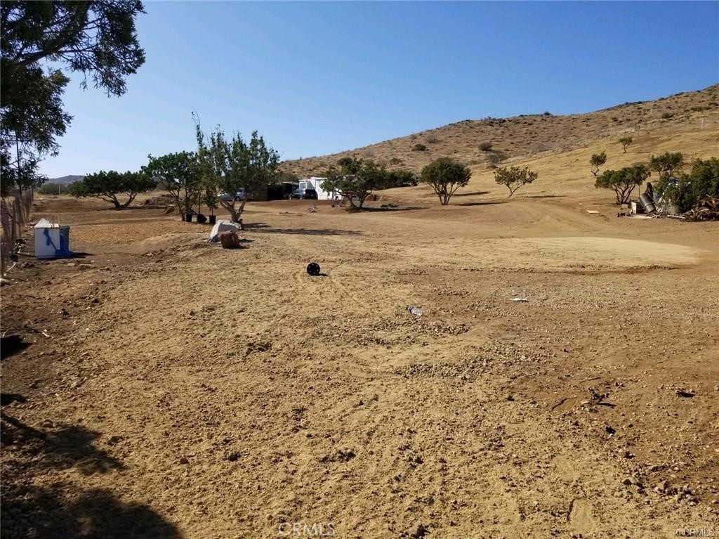 a view of a dry yard with mountain