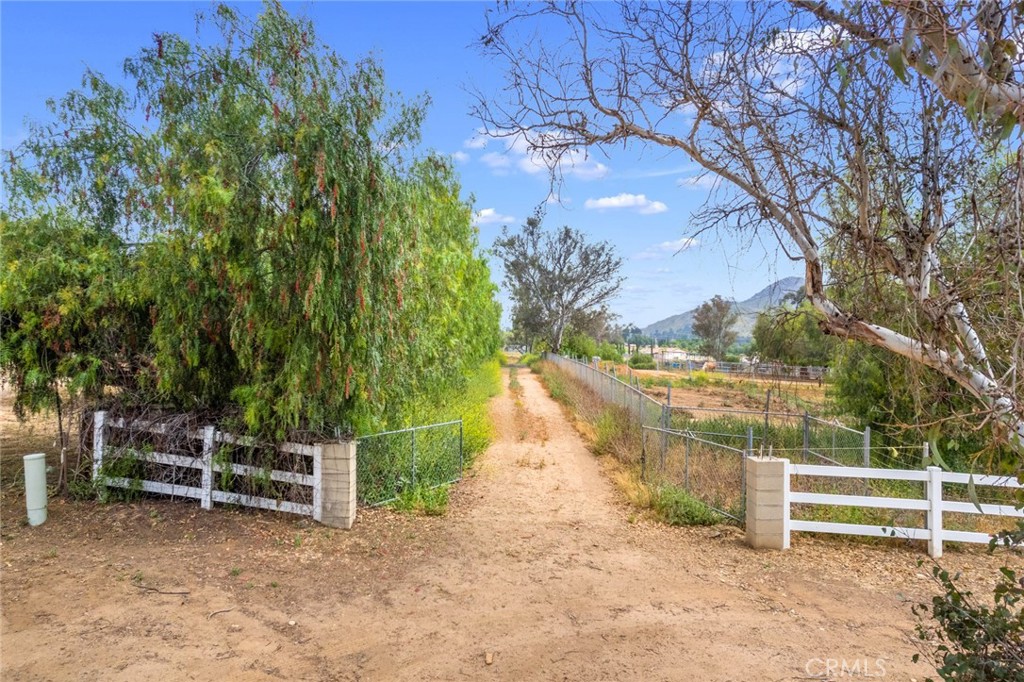 a view of a yard with wooden fence