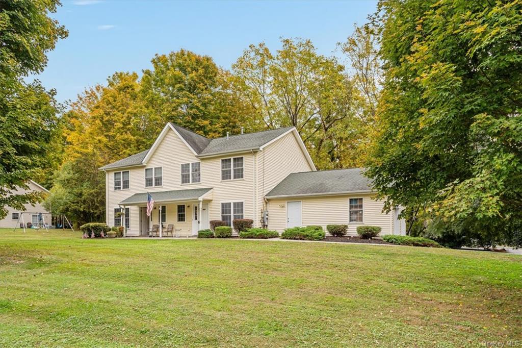 View of front of property featuring a front yard and covered porch