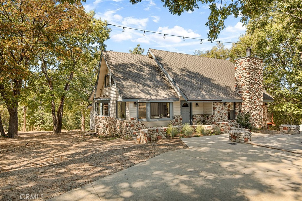 a front view of house with yard outdoor seating and barbeque oven