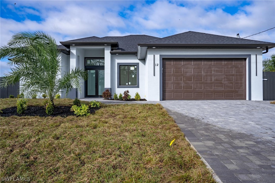 a front view of a house with a yard