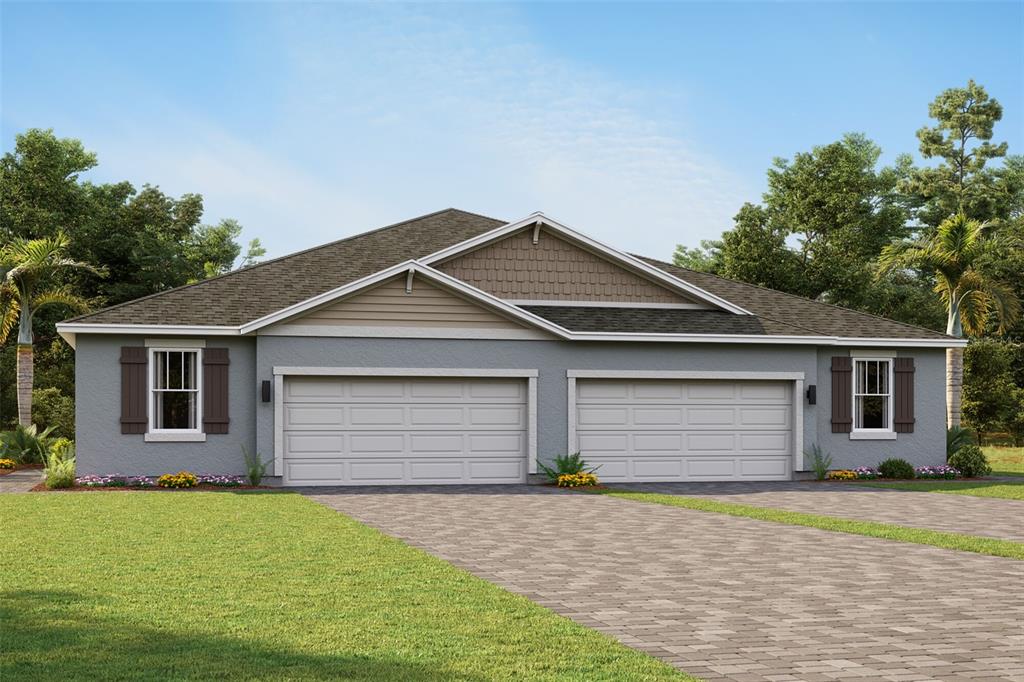 a front view of house with yard and trees in the background