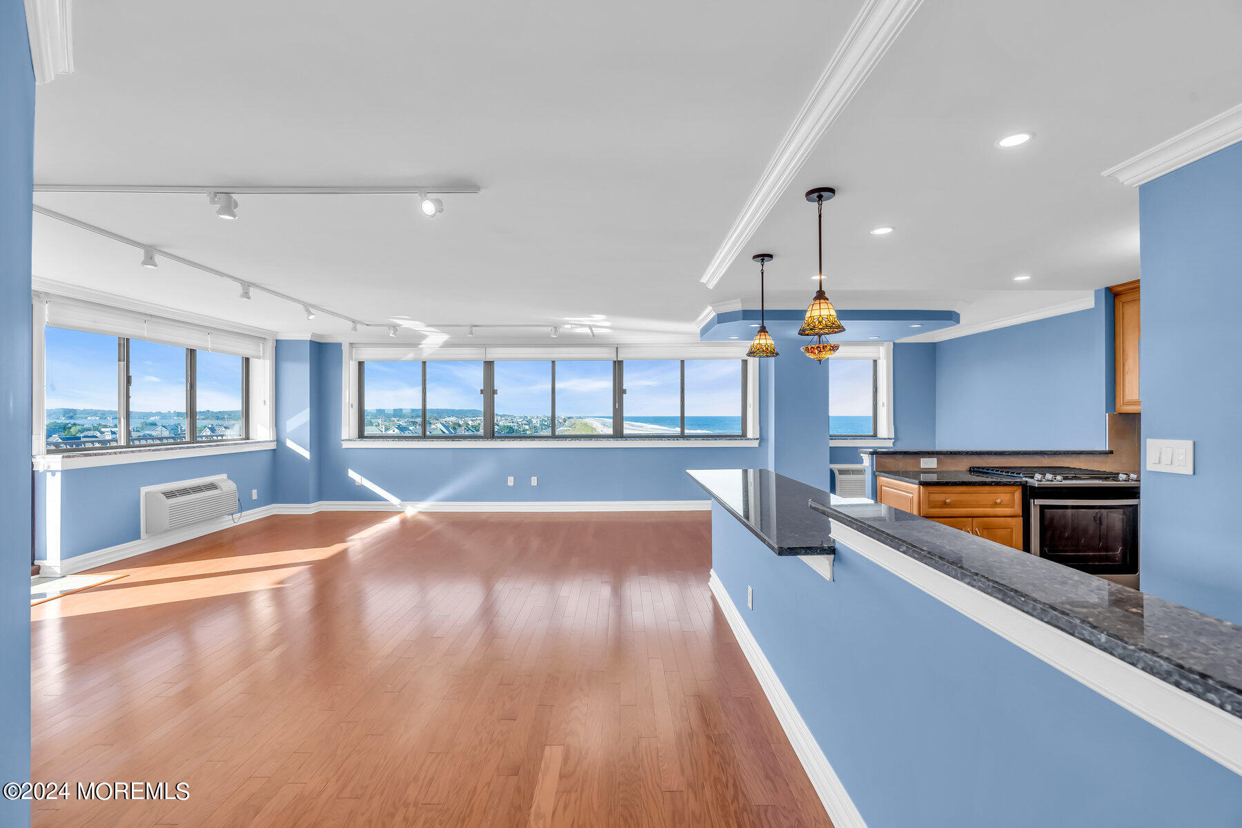 a large kitchen with stainless steel appliances a large counter top