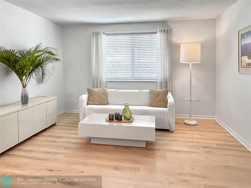 a living room with furniture and a potted plant