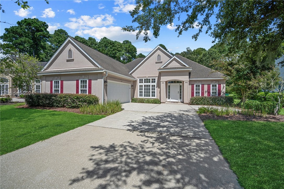 View of front of home with a front yard and a side