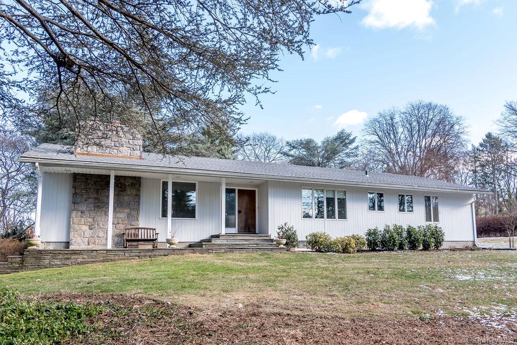 a view of a house with backyard and porch