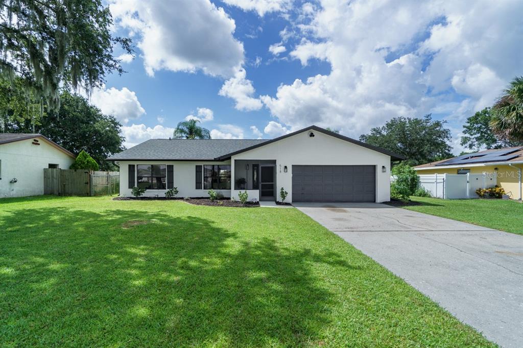 a front view of house with yard and green space