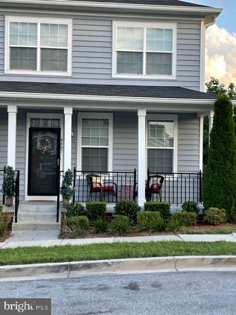 a front view of a house with a yard and plants