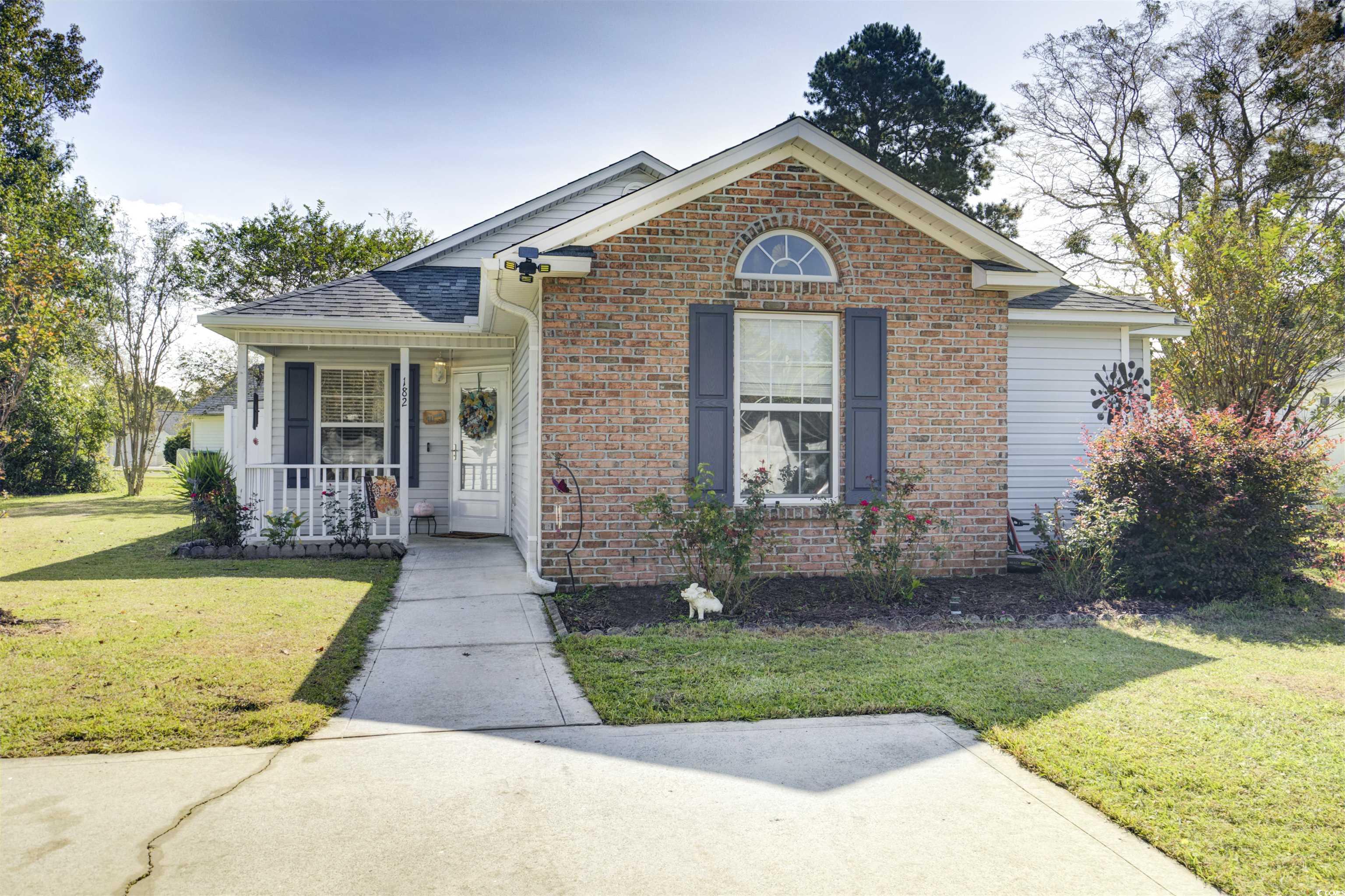 Bungalow with a front yard and a porch