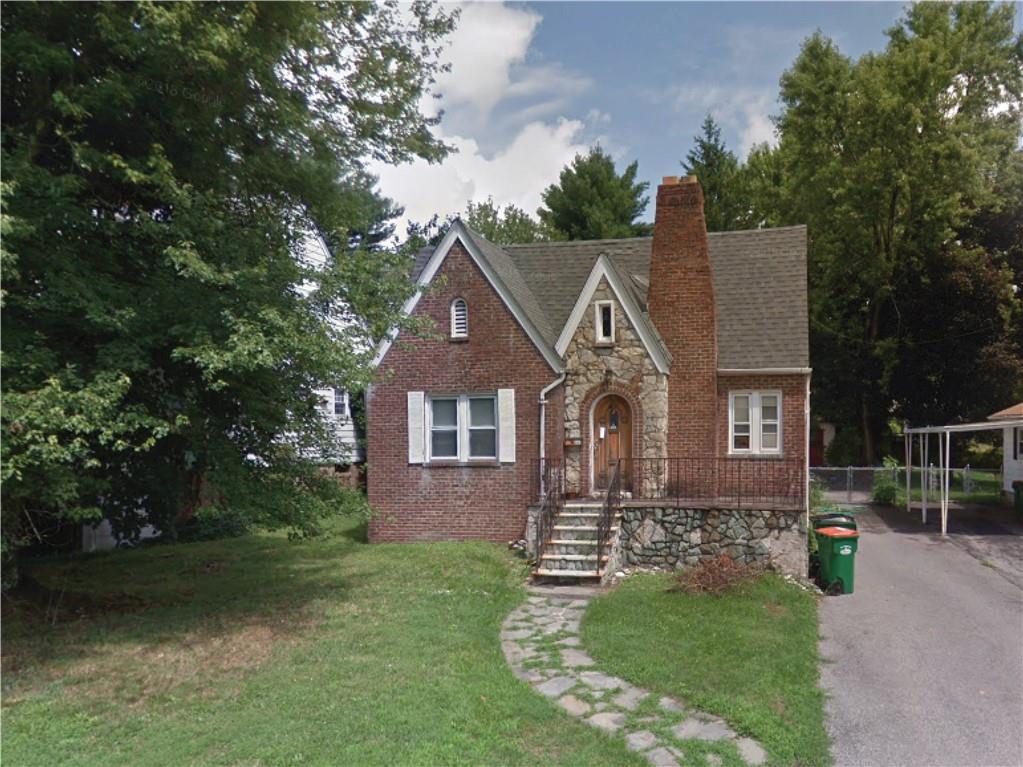 a front view of a house with a garden