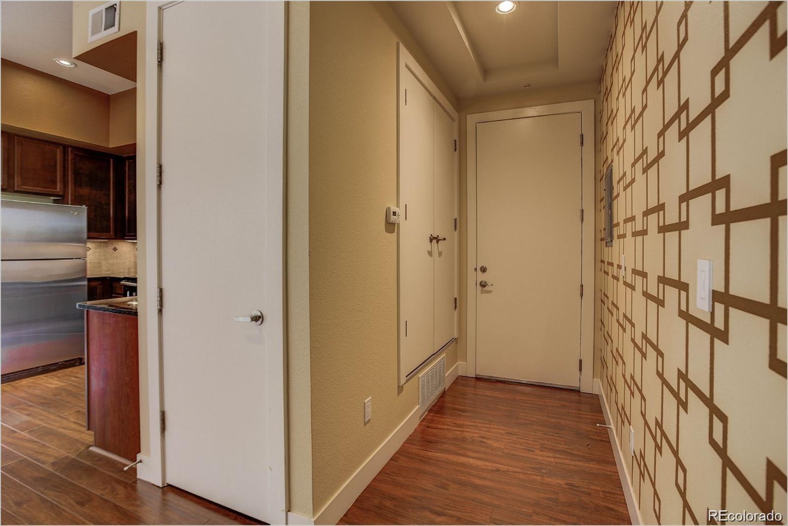 a view of hallway with stairs and wooden floor