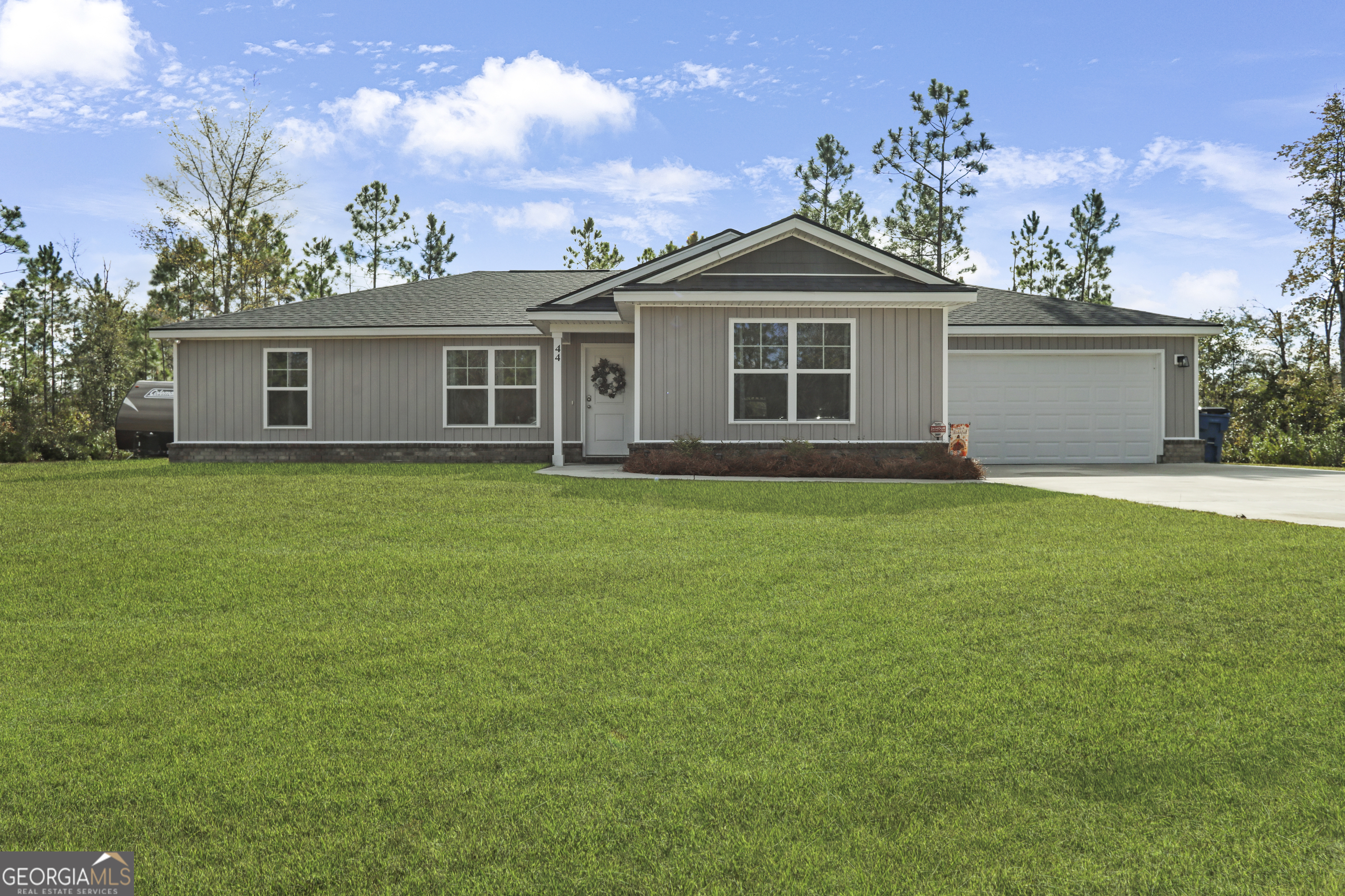 a front view of house with yard and green space