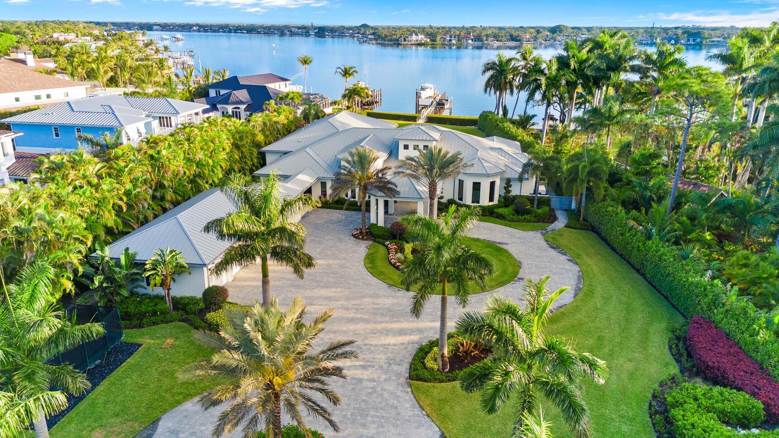 an aerial view of residential houses with outdoor space and swimming pool