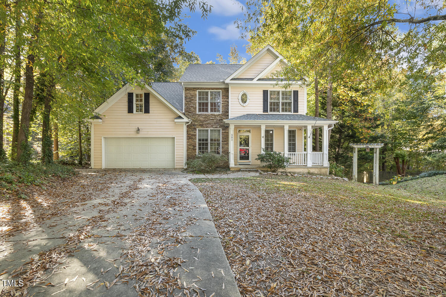 a front view of a house with a yard and trees