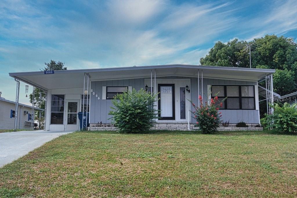 a front view of house with yard and green space