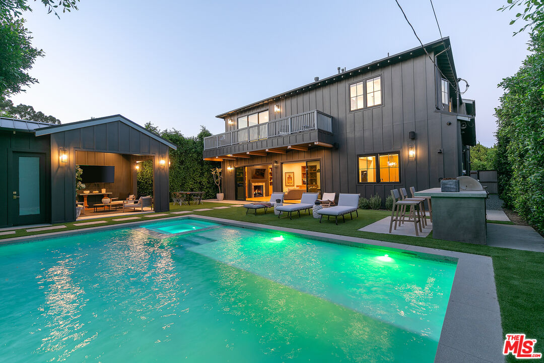 a view of swimming pool with seating area and garden