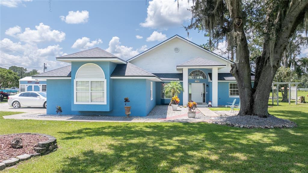 a view of a house with swimming pool and porch