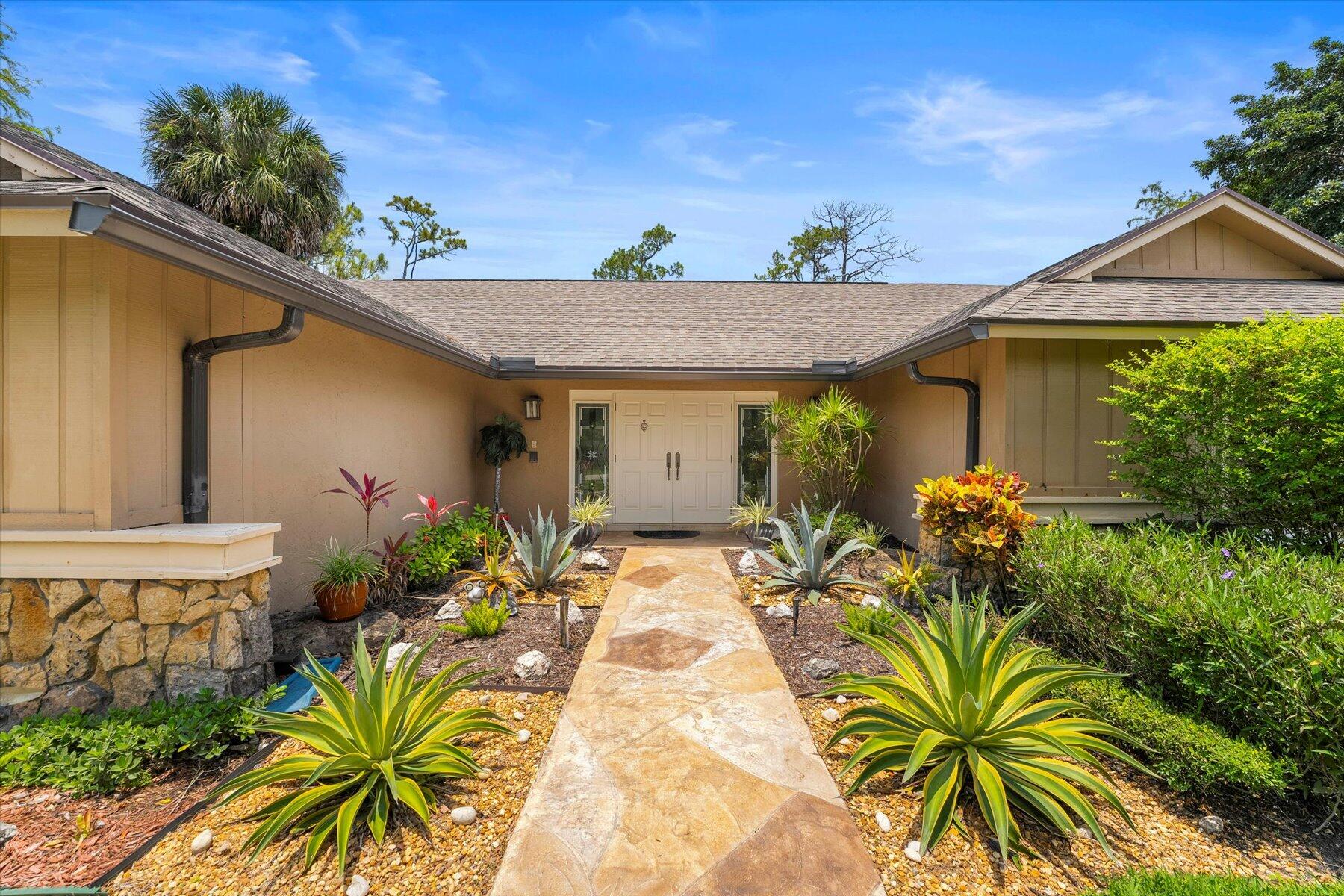 a view of a house with potted plants