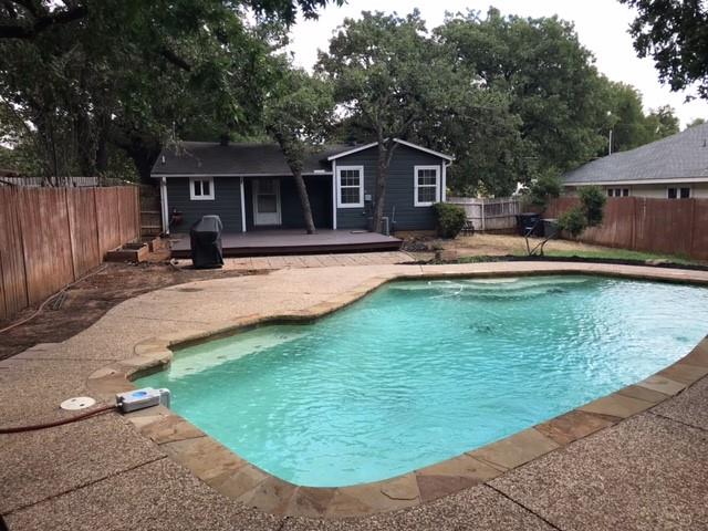 a view of a house with swimming pool and sitting area