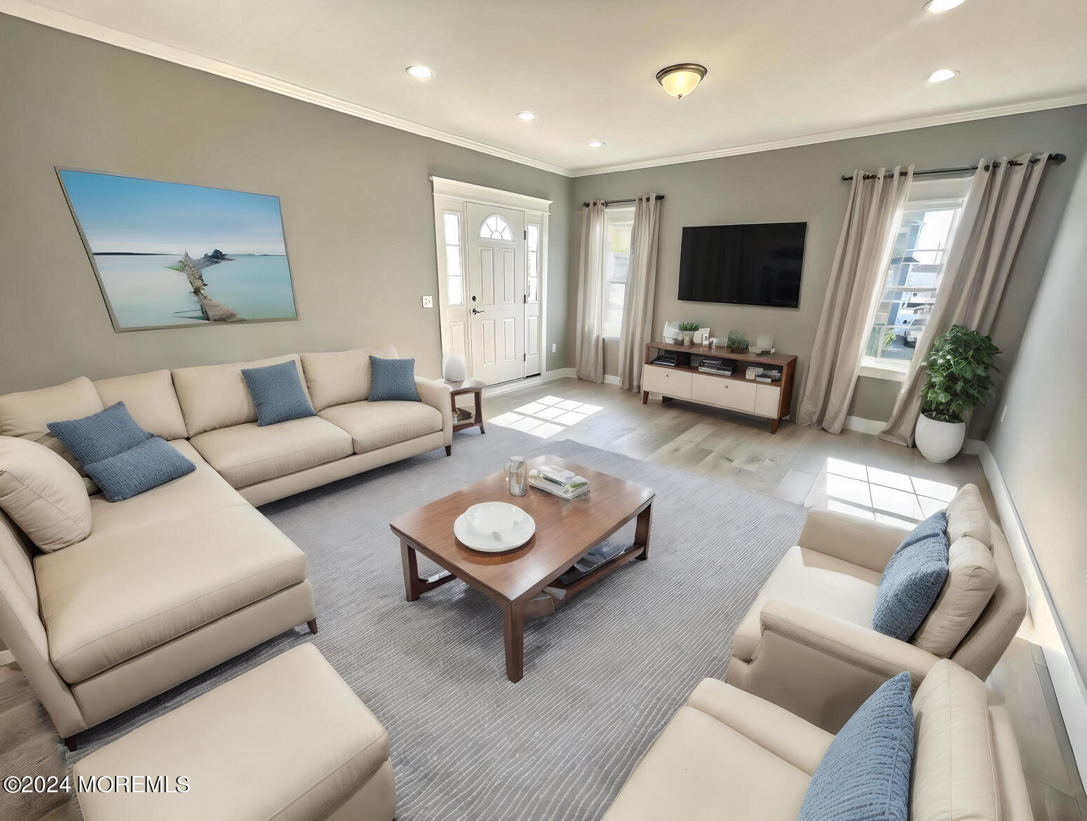 a living room with furniture and a flat screen tv